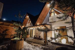 a house in the snow at night at Krzeptówki House in Zakopane