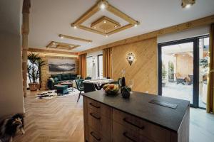 a kitchen with a counter and a living room at Krzeptówki House in Zakopane