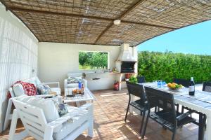 eine Terrasse mit einem Tisch, Stühlen und einem Grill in der Unterkunft Owl Booking Villa Divina - Luxury Retreat in Pollença