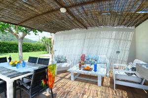 eine Terrasse mit einem Tisch und einem Sofa in der Unterkunft Owl Booking Villa Divina - Luxury Retreat in Pollença + 37 Fotos