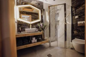 a bathroom with a shower and a sink and a mirror at Krzeptówki House in Zakopane +50 photos