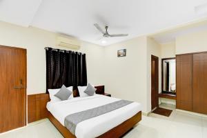 a bedroom with a large bed and a window at Hotel Velvet Stay Near DLF Cyber City in Hyderabad