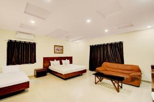 a hotel room with a bed and a couch at Hotel Velvet Stay Near DLF Cyber City in Hyderabad +34 photos