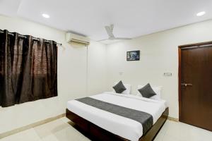a bedroom with a bed and a window at Hotel Velvet Stay Near DLF Cyber City in Hyderabad