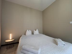 una camera da letto con un letto con due cuscini e una candela di Résidence Cloche verte a Bourges