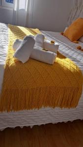 a bed with towels on top of it at Piso La Cumbre - CEE in Cee