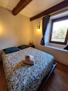 a bedroom with a bed with a teddy bear on it at L'Appart' du Château - Annecy 15 min in Alby