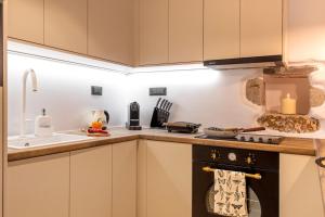 a kitchen with a stove top oven next to a sink at stema suite 1 in Tripiti +20 photos