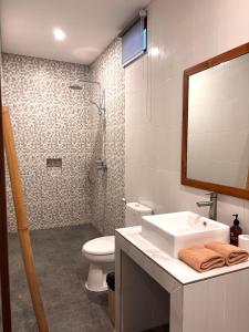 a bathroom with a sink and a toilet and a shower at Kampana Homestay in Uluwatu +32 photos