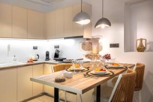 a kitchen with a wooden table with food on it at stema suite 1 in Tripiti
