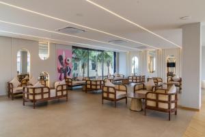 a waiting room with chairs and tables and a salon at Mangalam Resort & Spa - Member of Absolute Collection in Aurangabad
