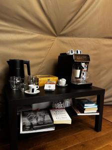 a black table with a coffee maker and a coffee pot at Princess Milena in London +25 photos