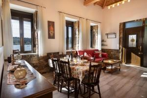 a living room with a table and chairs and a couch at Seaside Stone Retreat in Salamina