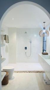 a white bathroom with a shower and a toilet at Mayara pool villas - Adults only in Haad Yao +53 photos