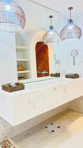 a kitchen with a white counter with a mirror at Mayara pool villas - Adults only in Haad Yao