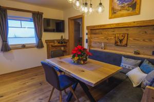 a dining room table with a vase of flowers on it at Appartement Aichner in Mittersill