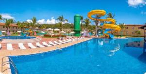 a pool at a resort with a water slide at Portobello in Porto Seguro