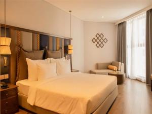 En eller flere senge i et værelse på Mandala Mui Ne - Beach & Pool Suites + 15 billeder