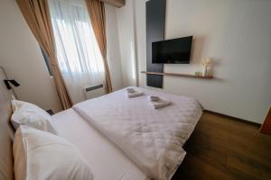 a hotel room with a bed and a flat screen tv at Zlatibor Pine & Peak in Zlatibor +27 photos
