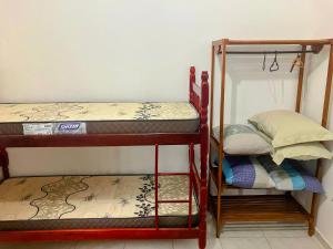 a room with two bunk beds in a room at Residencial Camirys in Itapoa