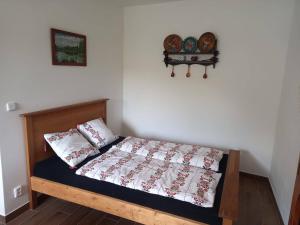a bedroom with a bed with two pillows on it at U rybníčku in Bzová