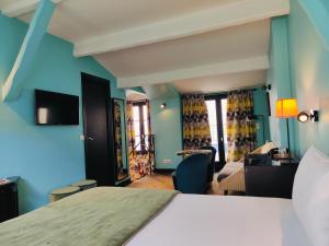 ein Hotelzimmer mit Bett und Wohnzimmer in der Unterkunft Hôtel Noir in Paris