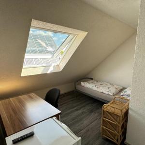 ein kleines Zimmer mit einem Bett und einem Fenster in der Unterkunft GMA Apartment H26 in Mahlberg