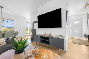 a living room with a flat screen tv on a wall at Strandgeflüster in Olpenitz +25 photos