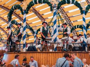 a group of men performing on a carousel at Munich Oktoberfest Bavarian Camping Village with breakfast & welcome beer in Munich