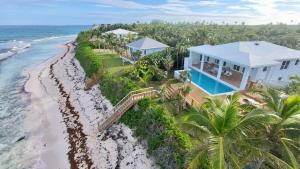 an aerial view of a house on the beach at 8 Bedroom Ocean Front in Eleuthera Double Bay with pool in Savannah Sound