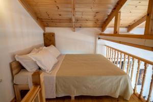 a bedroom with a bed in a room with stairs at Seaside Stone Retreat in Salamina