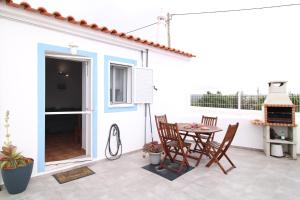 a patio with a table and chairs on a balcony at Sentinela Place in Azinhal