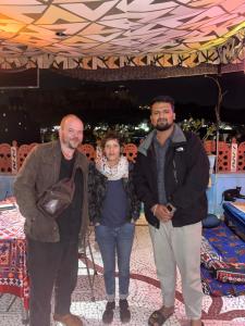 a group of three people posing for a picture at Musa's Homestay in Jodhpur