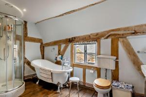 a bathroom with a tub and a sink and a toilet at 3 Bed in Rumburgh oc-c27094 in Rumburgh