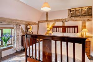 a bedroom with a wooden bed and a staircase at 3 Bed in Rumburgh oc-c27094 in Rumburgh