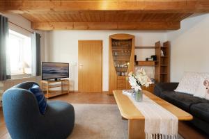 een woonkamer met een bank en een tafel bij Tuttelduven in Bisdorf