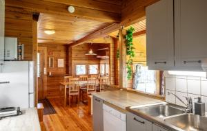 a kitchen and dining room of a log cabin at Mökki Syrjälä in Puumala