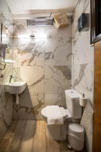 a bathroom with a toilet and a sink at Seaside Stone Retreat in Salamina +41 photos