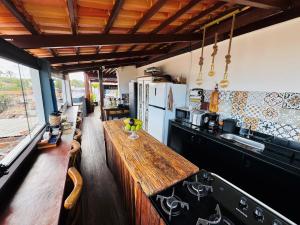 a kitchen with a wooden counter top in a room at Residence Pipa Beach in Pipa