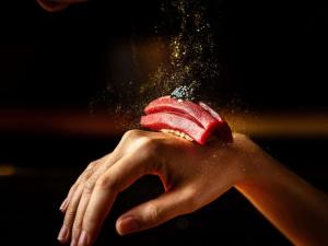 a person holding an ice cream in their hand at VIE Hotel Bangkok - MGallery Collection in Bangkok