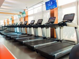 a row of tread machines in a gym at VIE Hotel Bangkok - MGallery Collection in Bangkok