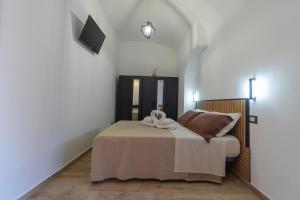 una camera da letto con un letto e un asciugamano sopra di Costa Apartment a Catania