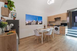 una cucina con un tavolo e sedie in una stanza di Costa Apartment a Catania