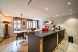 a kitchen with a large black counter top in a room at LA FERME D'AGATHE in Abondance