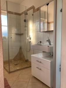 a bathroom with a shower and a sink at Sissy Appartment in Kössen