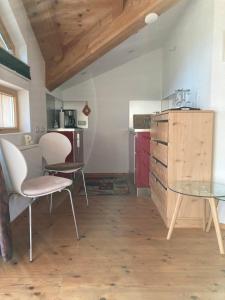 a kitchen with a table and chairs in a room at Sissy Appartment in Kössen +24 photos