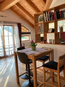 a wooden table and chairs in a room at Sissy Appartment in Kössen