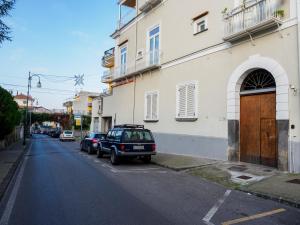 a car parked in a parking lot next to a building at Ficus Home - De Vivo Realty in Sant'Agnello