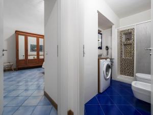 a bathroom with a sink and a washing machine at Ficus Home - De Vivo Realty in Sant'Agnello +36 photos