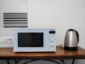 a microwave sitting on top of a wooden table at Ficus Home - De Vivo Realty in Sant'Agnello